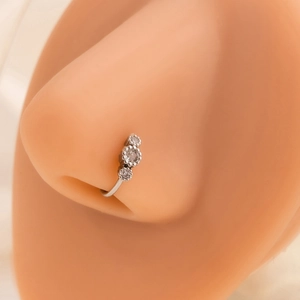 Close-up of a silver leaf-shaped nose ring with sparkling rhinestones on model's nose
