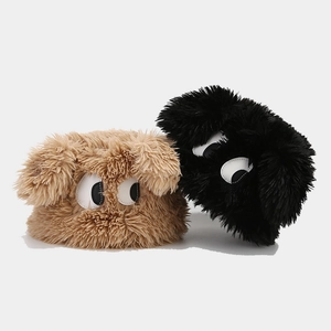 Plush winter hats in black and brown featuring creative large cartoon monster eyes