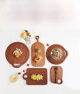 Flat lay of mini ebony wood cutting boards with various shapes and natural grain textures