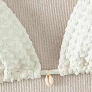 White popcorn fabric bikini set with natural cowrie shell and gold ring accents