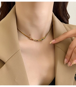 Detail of gold snake chain necklace featuring nine colorful round cubic zirconia stones