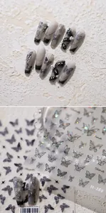 Vue macro des autocollants d'ongles papillon M-269 avec motifs laser argent et noir