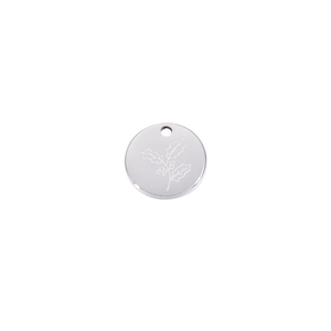 Macro shot of silver stainless steel round pendant with engraved holly leaf and berry pattern