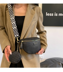 Detail of black woven chest bag with round coin purse and geometric pattern wide strap