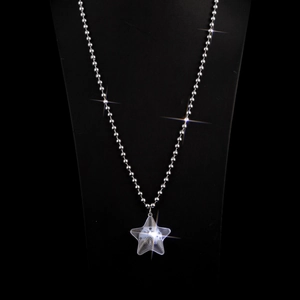 Detail of a sparkling silver star pendant on a bead chain necklace for women