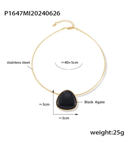 Detailed view of triangular black agate pendant on a gold stainless steel necklace