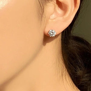 Close-up of 925 sterling silver six-prong stud earrings with round brilliant zircon stones