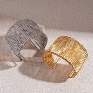 Minimalist geometric twisted wire open cuff bracelet in gold and silver finish