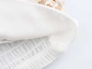Detail of white beach set showing inner lining seams and elastic smocked waist design