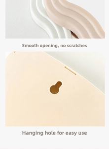 Detail of smooth wavy edge and back hanging hole of the creamy desktop makeup mirror