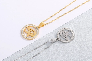 Detailed macro view of gold and silver Eye of Horus pendants with pavé rhinestones