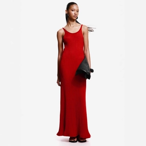 Close-up of red ribbed knit texture and slim fit design of this long backless dress