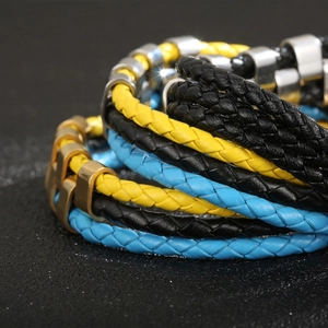 Detail of multilayer woven leather bracelet with yellow, blue and black braided cords