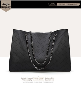 Close-up of quilted black tote bag featuring lychee grain texture and metal chain straps