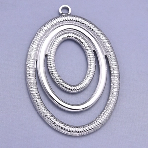 Macro detail of oval silver stainless steel triple layered concentric ring pendant
