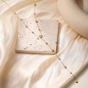 Elegant 18K gold plated heart necklace with zircon crystals on beige silk and stone
