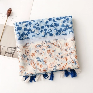 Detail of boho shawl with leopard paisley patchwork and navy blue fringe tassels