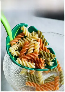 Close-up of green leaf-shaped pasta spoon draining cooked fusilli in a kitchen setting
