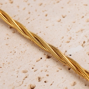 Three-strand twisted gold snake chain bracelet with minimalist punk style design