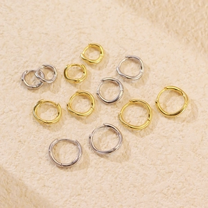 Polished S925 silver wave ear cuffs in gold and silver on a textured stone base