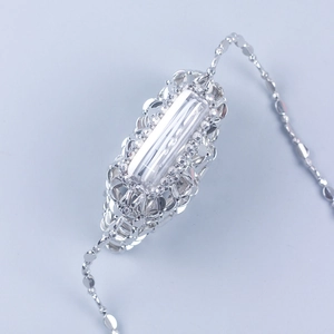 Handmade silver woven bracelet featuring a large rectangular crystal and intricate metalwork