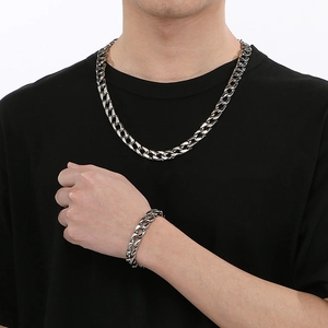 Men's 12mm silver stainless steel Cuban link necklace and bracelet set on model