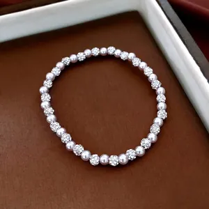 Elegant rhinestone and pearl beaded bracelet for women in a luxury gift box display