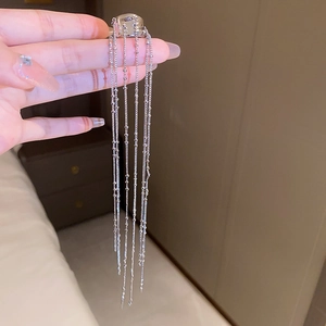 Detail of silver long chain tassel ear cuff with multiple dangling metal strands