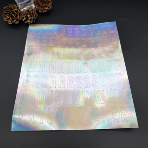 Close-up of holographic laser alphabet stickers with complete A-Z letter design on black base