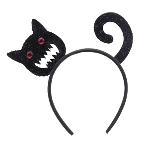Close-up of black sequined cat headband for Halloween party with red eyes detail