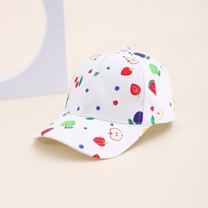 Close-up of white kid baseball cap featuring colorful strawberry and watermelon prints