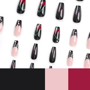 Black and rose press-on nails with star patterns and rhinestones in coffin shape