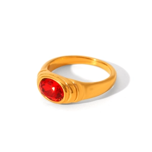 Close-up of a gold-plated ring featuring an oval red zircon stone with wave details