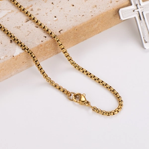 Minimalist gold square box chain necklace with lobster clasp on beige stone background