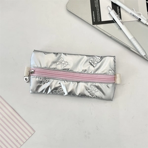 Detail of silver metallic pencil case with bow embossing and flower zipper pull