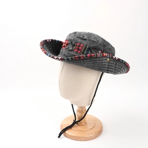 Detail of grey cotton sun hat with colorful ethnic embroidery and adjustable wind cord