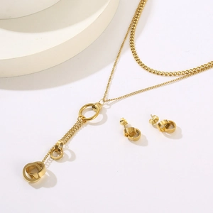 Detail view of 18K gold plated double layer necklace set with triple ring tassels