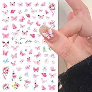 Detail of pink butterfly and floral nail art stickers applied on manicured nails