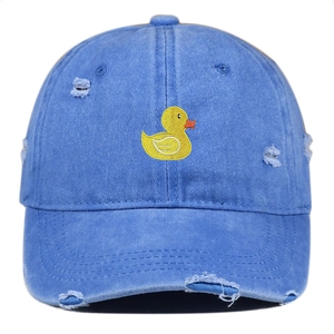 Close-up of duck embroidery and distressed torn details on blue washed cotton cap