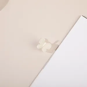 Detailed view of mini butterfly hair claw with small pearls on cream white wings