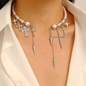 Detail of silver pearl choker featuring dangling cross and spike pendants on model