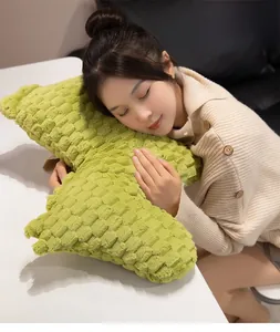 Soft green plush nap pillow with waffle texture shown in a comfortable usage scene