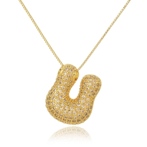 Detailed close-up of gold bubble letter U pendant necklace with inlaid zircons
