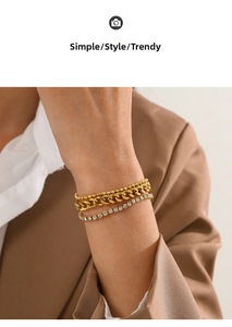 Detailed view of layered gold-plated bracelet set with curb chain and sparkling rhinestones