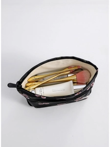 Vintage floral jacquard makeup bag in black fabric with embroidery and beauty products