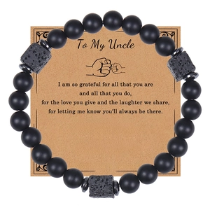 Close-up of black matte stone beaded bracelet on Uncle greeting card gift set