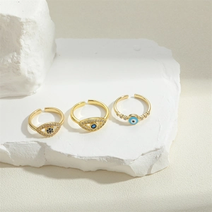 Three-piece gold Evil Eye rings set with blue zircons and adjustable open bands