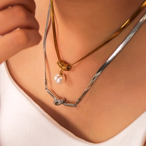 Layered gold snake chain with pearl pendant and silver knotted necklace set for women
