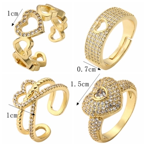 Detail view of four gold-plated heart rings with zircon inlay and precise dimensions