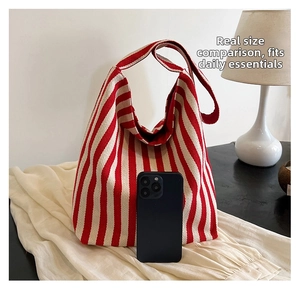 Close-up of red and white striped canvas tote bag showing material texture and size scale